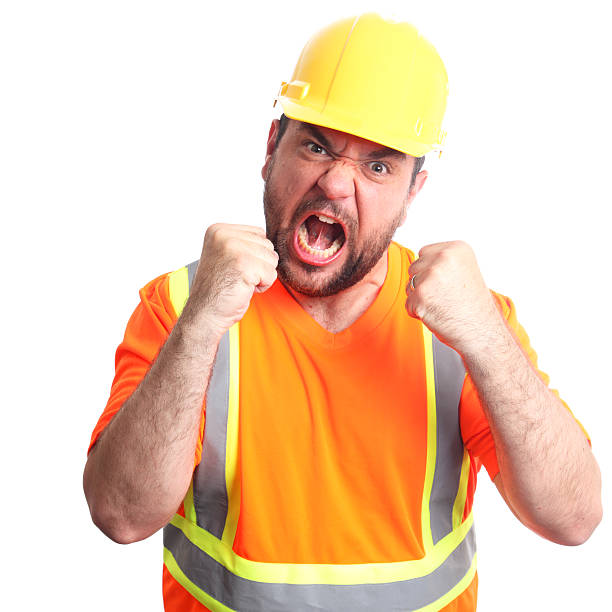 wütende bauarbeiter - construction safety mid adult men road construction stock-fotos und bilder