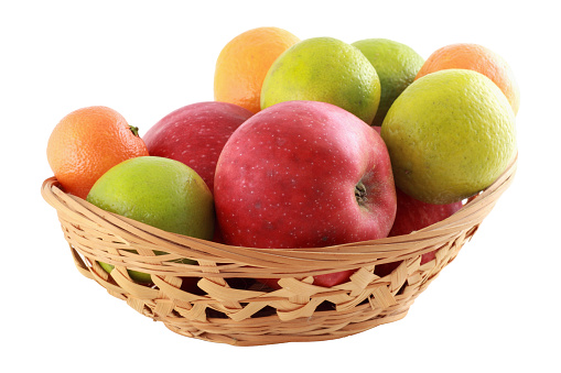coloured fruit in basket, white backgroun
