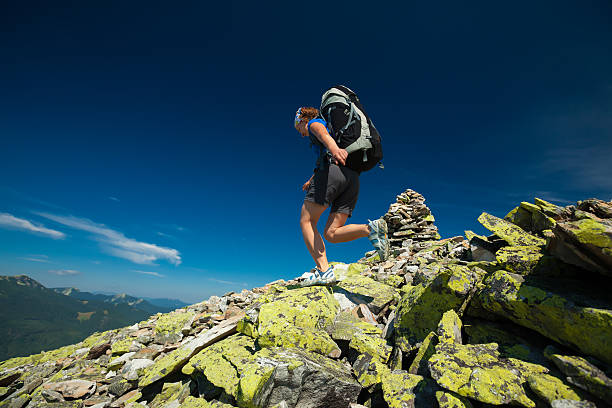 istock Hiker jumps over stones in mountains 500614724