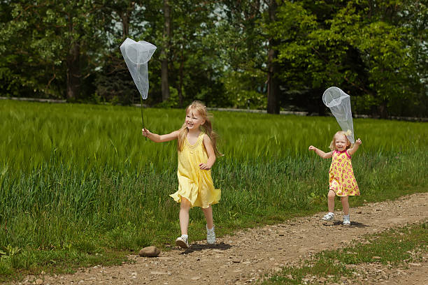 Asian boy and girl caught a butterfly in the garden
