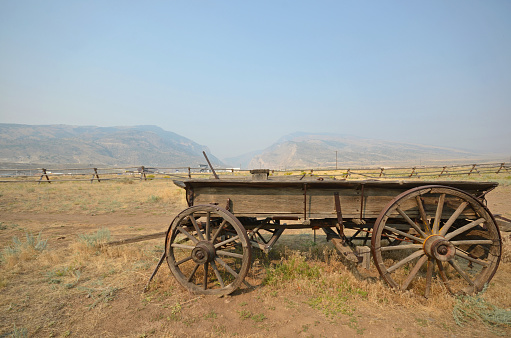Old wooden wagons used for transport, sheep and cattle watching in small town of Shell, Wyoming. The wagons are sitting by 1880 school house. Shell is near Greybull and Cody, Wyoming in western USA.