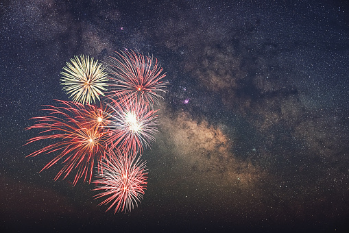 Fireworks set against the Milky Way.  Composite image.