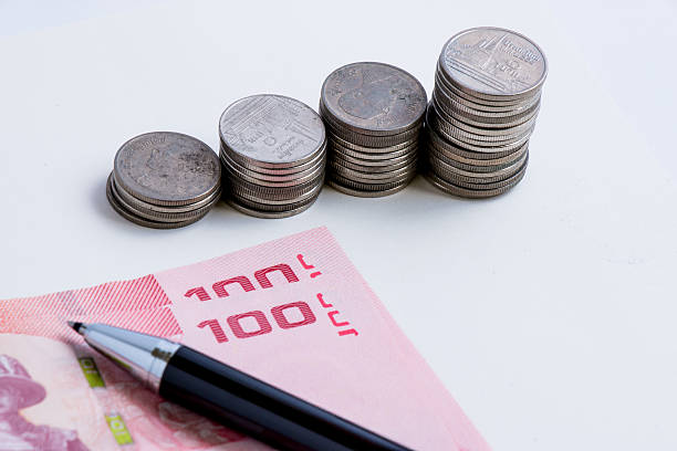 istock Coins setup in line graph put beside banknote. 500618738