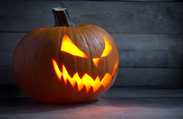 istock Scary face lack o lantern on wooden dark background 500619222