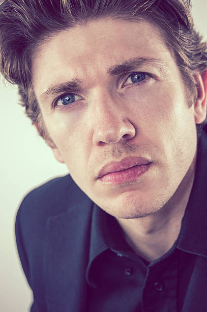 istock Headshot of a man leaning into camera giving attitude 500621872