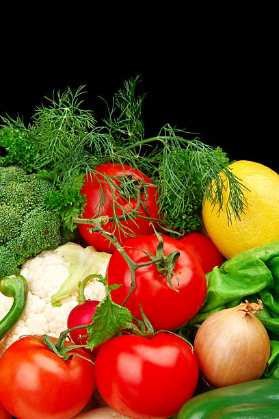 Group of different vegetables on black vertically