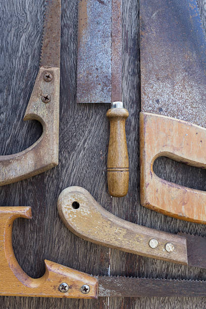 istock saws / old handsaws details on wooden background 500623582