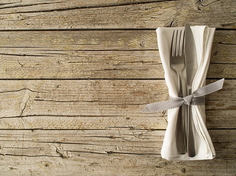 Cutlery kitchenware on old wooden boards background food concept