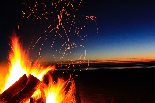 Beautiful Sunset behind a beautiful fire on a beach in Oregon