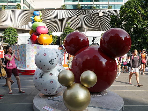 Bangkok, Thailand – December 4, 2015: People come to enjoy the Christmas decorations located in front of Central World Shopping Mall in Bangkok. Three are different kind of decorations for tourists and locals to take photos with. There are Walt Disney’s decoration. Some walk around the area. Some take photos.