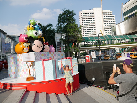  Bangkok, Thailand – December 4, 2015: People come to enjoy the Christmas decorations located in front of Central World Shopping Mall in Bangkok. Three are different kind of decorations for tourists and locals to take photos with. There are Walt Disney’s decoration. Some walk around the area. Some take photos.