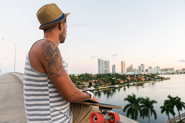 istock Man With Skateboard Looks at Scenic Miami View 500639014