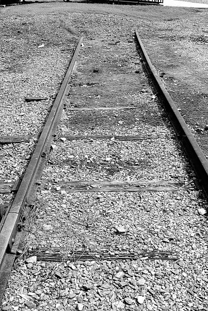 istock Old train tracks end into a dirt pile 500639422