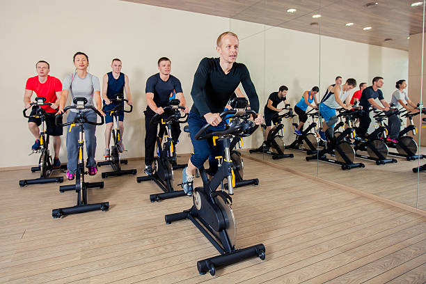istock Group of gym people on machines, cycling In Class 500642398