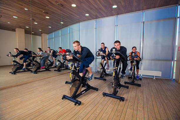 istock Group of gym people on machines, cycling In Class 500642448