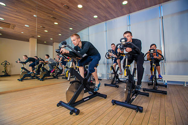 istock Group of gym people on machines, cycling In Class 500642468