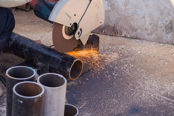 istock electric saw and hands of worker 500643616