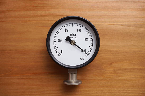 istock pressure gauge on wood background 500645784