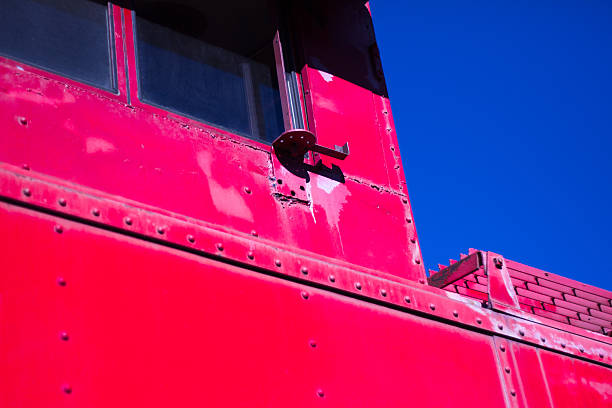 istock Close-Up of Red Caboose Against Deep Blue Sky 500645957