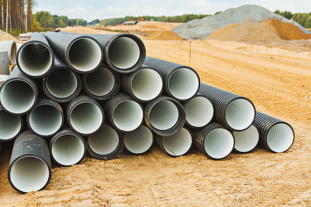 istock pile of big pipes on construction site 500647613