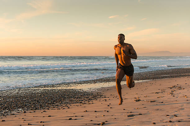 istock Muscular Man Running On The Beach At Sunset 500648780