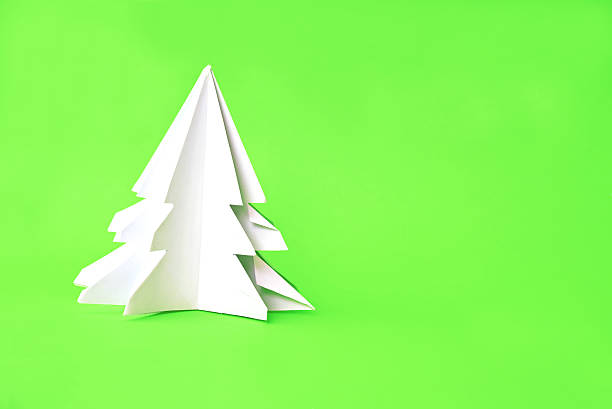 istock Origami Christmas tree paper on green background 500649770