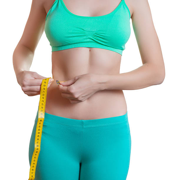 istock Young woman measuring her waist. 500650124