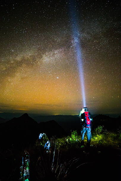istock Young man Standing on Mountain with night sky 500650411