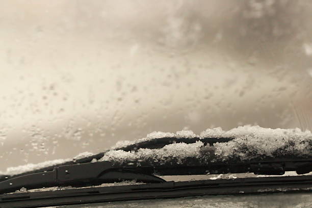istock Winter‘s car traveling - snow on windscreen wiper 500650636