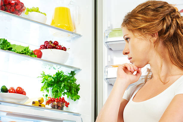 istock Happy woman and open refrigerator with fruits, vegetables and he 500650708