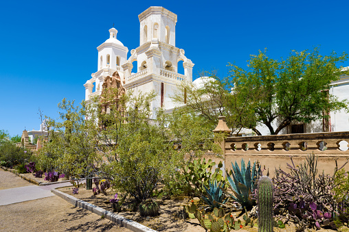 San Xavier del Bac Mission, White Mission Church Building, Tucson, Arizona, cactus, desert. Clear blue sky