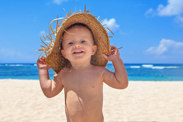 istock Smiley child with hat has fun on sea sand beach 500653036