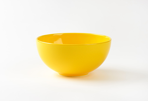 empty yellow bowl on white background