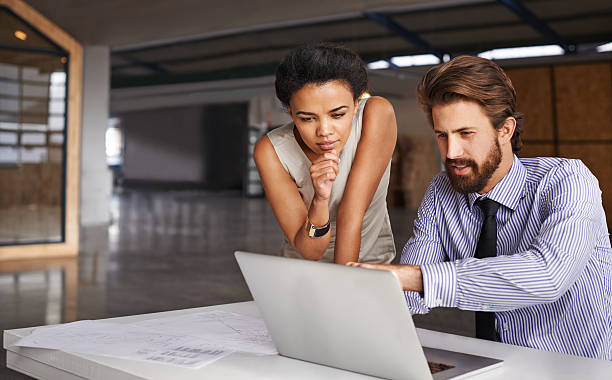 What do you think of that feature over there? Shot of two architects working together at a laptophttp://195.154.178.81/DATA/i_collage/pu/shoots/806088.jpg architect office stock pictures, royalty-free photos & images