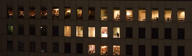 istock People busy in a skyscraper at night 500663685