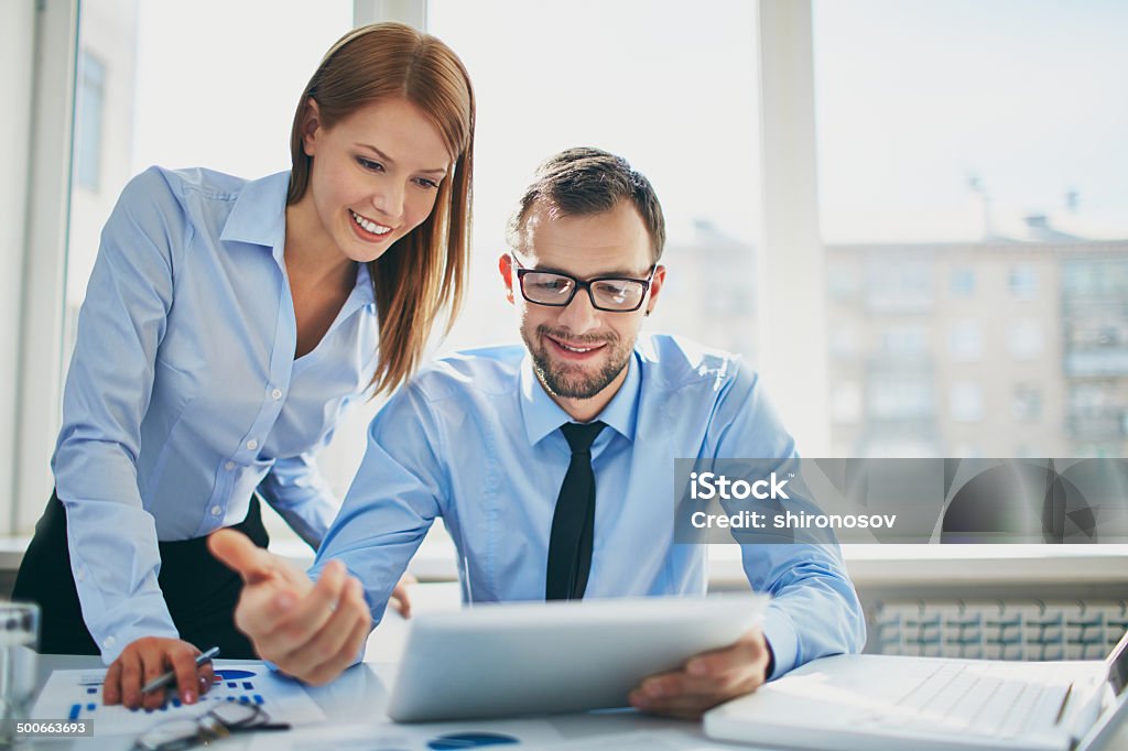 Office work Image of two successful business partners working at meeting in office Adult Stock Photo