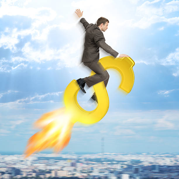 istock Businessman flying on dollar sign 500665894
