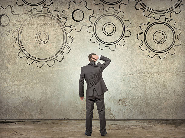 istock Businessman looking at cog wheels, rear view 500666088