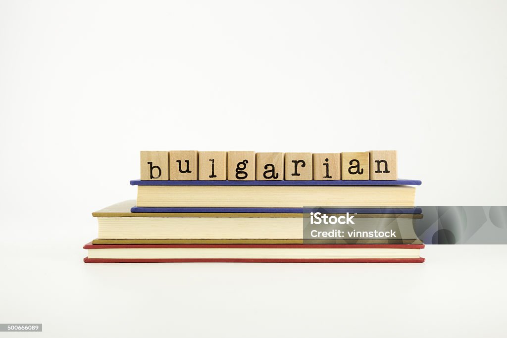 Bulgarian language word on wood stamps and books Bulgarian word on wood stamps stack on books, language and conversation concept Advice Stock Photo