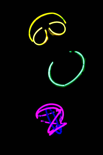 istock Person wearing colorful neon glow sticks at night 500666888