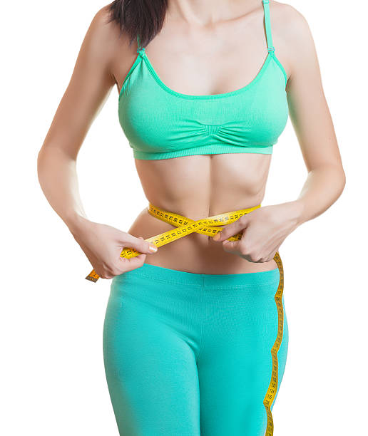 istock Young woman measuring her waist. 500667092