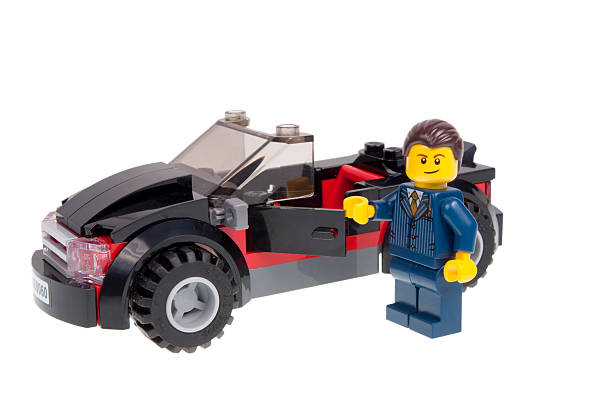 händler lego minifigure mit schwarz sport auto - sports car car business editorial stock-fotos und bilder