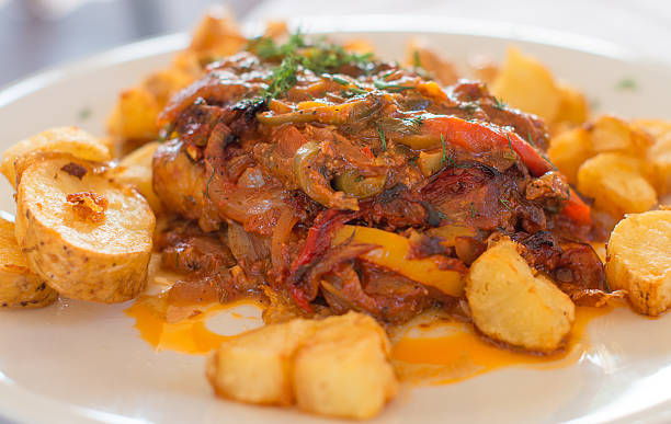 istock Fish with tomato sauce and fried potatoes. 500667696