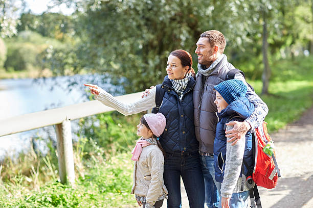 istock happy family with backpacks hiking 500668062