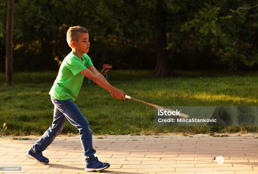 Cute mixed race teenager with a tennis racket Afro American boy on playground Tennis Stock Photo