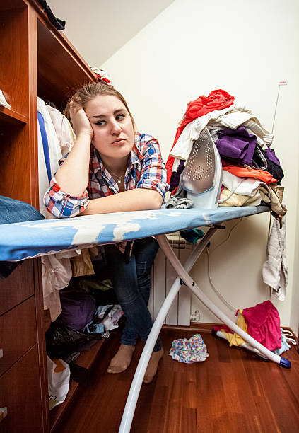 istock depressed housewife leaning against ironing board 500668587