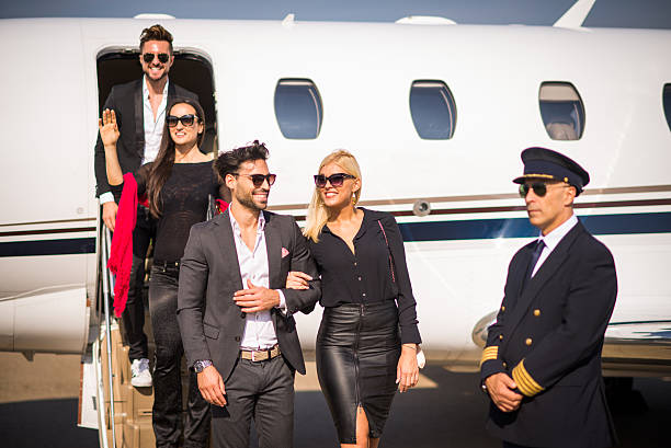 istock Four people leaving private jet airplane 500668934