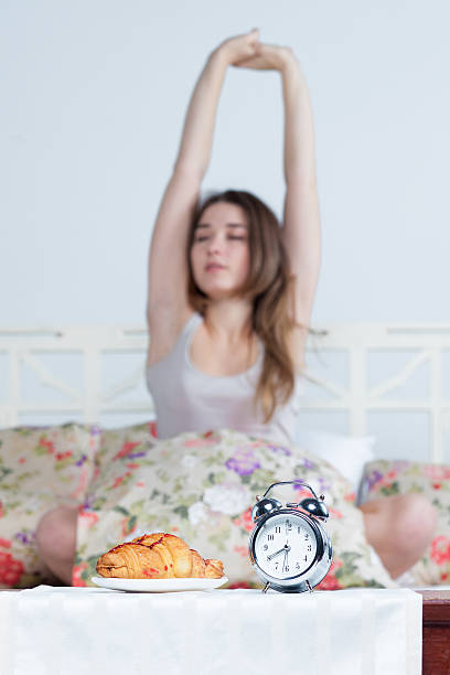 istock The young girl in bed with  clock service 500670026