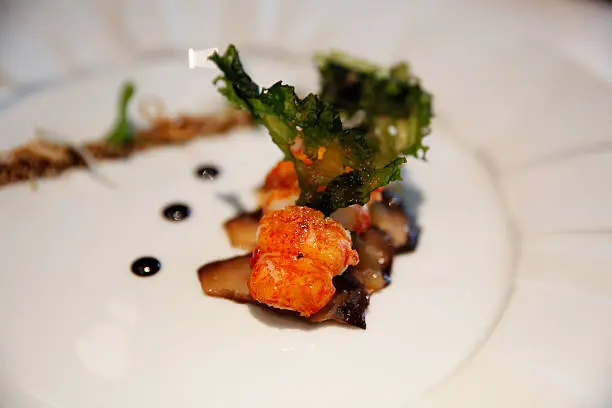 Roasted marron accompanied by an umami bomb of confit konbu, tamari-glazed sesame seeds and dried sea lettuce