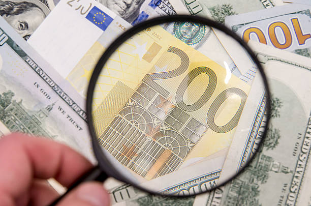 istock Magnifying glass over 200 euro notes. US dollar as background 500671622